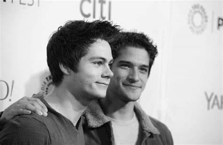 Dapper: Dylan O'Brien cut a smart figure with a palm tree patterned shirt and navy trousers
